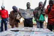 Kenyans read the morning newspapers following the Pandora Papers revelations that President Uhuru Kenyatta is among the beneficiaries of secret financial accounts, Nairobi, Kenya, Oct. 5, 2021 (AP photo by Brian Inganga).