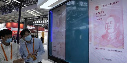 Workers demonstrate the use of the e-CNY, a digital version of the Chinese yuan, during the China International Fair for Trade in Services, Beijing, China, Sept. 5, 2021 (AP photo by Ng Han Guan).
