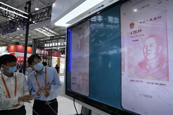 Workers demonstrate the use of the e-CNY, a digital version of the Chinese yuan, during the China International Fair for Trade in Services, Beijing, China, Sept. 5, 2021 (AP photo by Ng Han Guan).