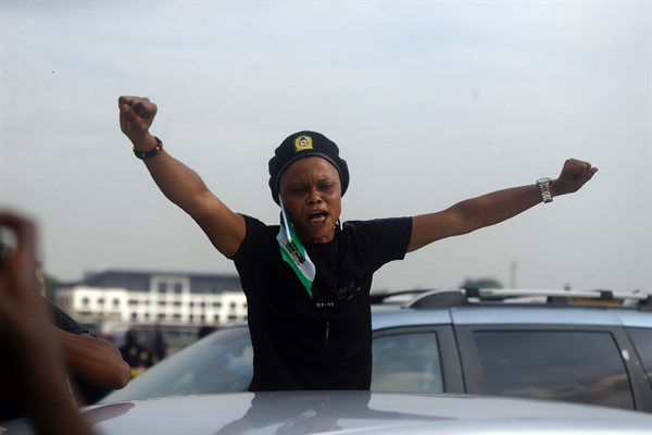 A woman protests at Lekki Toll plaza on the one-year anniversary of the #EndSARS demonstrations against police brutality, Lagos, Nigeria, Oct. 20, 2021 (AP photo by Sunday Alamba).