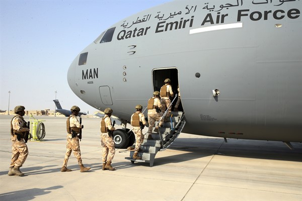 Qatari airmen board a transport plane evacuating people at Hamid Karzai International Airport in Kabul, Afghanistan, August 18, 2021 (Qatar Government Communications Office photo via AP).