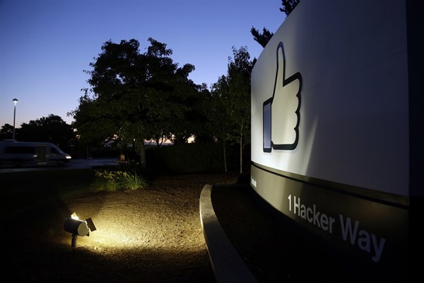 The Facebook “like” symbol is illuminated on a sign outside the company’s headquarters in Menlo Park, Calif, Jun 7, 2013 (AP photo by Marcio Jose Sanchez).