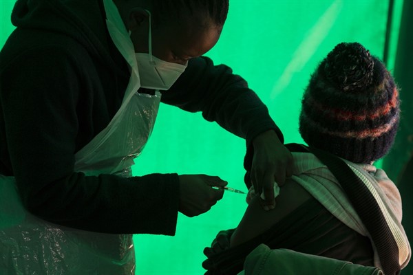 An elderly patient receives a dose of a COVID-19 vaccine at a clinic at Orange Farm, near Johannesburg, South Africa, June 3, 2021 (AP photo by Denis Farrell).