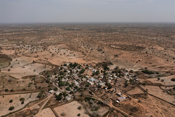 A desolate, semi-arid landscape surrounds the Sahel village of Ndiawagne Fall in Kebemer, Senegal, Nov. 5, 2021 (AP photo by Leo Correa).