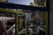 An Afghan inspects the damage at the Ahmadi family house after a U.S. drone strike killed Zemari Ahmadi and nine other family members on Aug. 29, Kabul, Afghanistan (AP file photo by Bernat Armangue).