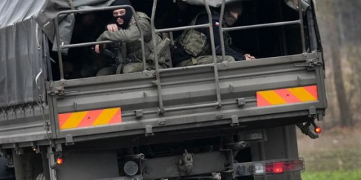 Polish soldiers sit on an army vehicle as they drive past a checkpoint close to the border with Belarus in Kuznica, Poland, Nov. 16, 2021 (AP photo by Matthias Schrader).