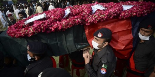 Police officers carry a casket of a colleague who was killed in a grenade attack, Peshawar, Pakistan, July 30, 2021 (AP photo by Muhammad Sajjad).