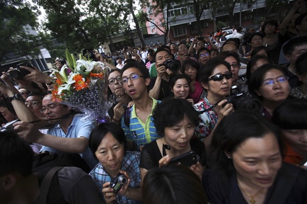 Chinese relatives and friends wait for students after the annual college entrance examinations in Beijing, June 8, 2010 (AP photo by Muhammed Muheisen).
