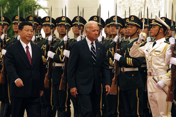 Then-U.S. Vice President Joseph Biden and then-Chinese Vice President Xi Jinping inspect a guard of honor during a welcome ceremony at the Great Hall of the People, Beijing, Aug. 18, 2011 (AP photo by Ng Han Guan).