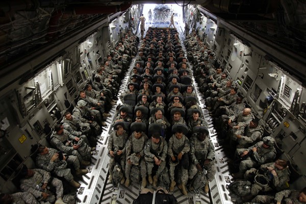 U.S. soldiers sit in a C-17 aircraft at Sather Air Base in Baghdad as they begin their journey home after a year in Iraq, Nov. 30, 2010 (AP photo by Maya Alleruzzo).