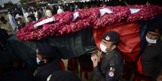 Pakistani Police officers carry a casket of a colleague who was killed in a grenade attack.