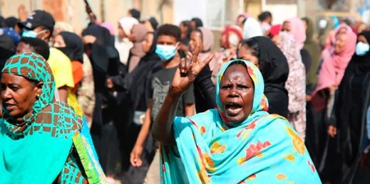 A pro-democracy protester flashes the victory sign during a protest against a military coup, Khartoum, Sudan, Oct. 25, 2021 (AP photo by Ashraf Idris).