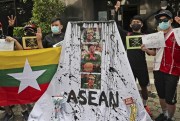 Activists display posters and defaced portraits of the leader of Myanmar’s junta, Min Aung Hlaing, during a rally protesting an emergency summit between him and Southeast Asian leaders, Jakarta, Indonesia, April 24, 2021 (AP photo by Tatan Syuflana).