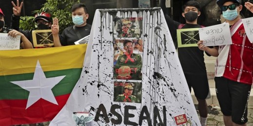 Activists display posters and defaced portraits of the leader of Myanmar’s junta, Min Aung Hlaing, during a rally protesting an emergency summit between him and Southeast Asian leaders, Jakarta, Indonesia, April 24, 2021 (AP photo by Tatan Syuflana).