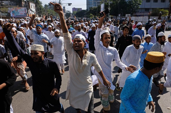 Muslim devotees shout slogans during a protest over an alleged insult to Islam, outside the country’s main Baitul Mukarram Mosque in Dhaka, Bangladesh, Oct. 15, 2021 (AP photo by Mahmud Hossain Opu).