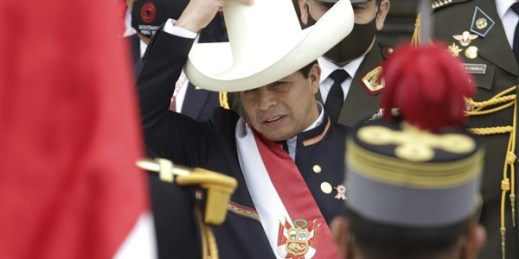 Peru's newly sworn-in president, Pedro Castillo, acknowledges the Peruvian flag held by soldiers outside Congress on his inauguration day in Lima, Peru, July 28, 2021 (AP photo by Francisco Rodriguez).