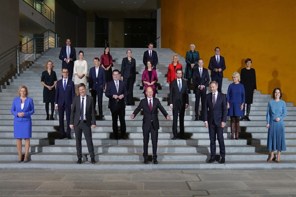 German Chancellor Olaf Scholz and his ministers pose for a photo after the first Cabinet meeting of the new German government at the Chancellery in Berlin, Germany, Dec. 8, 2021 (AP photo by Michael Sohn).