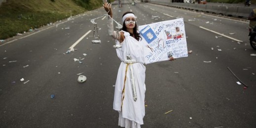 A protester dressed as as “Lady Justice” poses during a protest against Venezuelan President Nicolas Maduro in Caracas, Venezuela, Oct. 26, 2016 (AP photo by Rodrigo Abd).