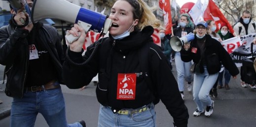 Youths demonstrate in Paris after French unions called for strikes and protests to demand more government aid for those struggling financially because of the pandemic, Feb. 4, 2021 (AP photo by Thibault Camus).