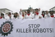 People take part in a demonstration to ban killer robots in front of the Brandenburg Gate, Berlin, March 21, 2019 (dpa photo by Wolfgang Kumm via AP Images).