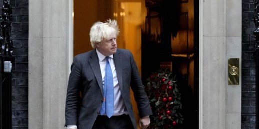 British Prime Minister Boris Johnson steps out of 10 Downing Street to welcome the Sultan of Oman, Haitham bin Tarik al-Said, in London, Dec. 16, 2021 (AP photo by Frank Augstein).