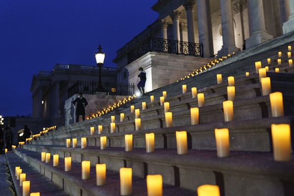 Candles are placed on the steps of the Capitol to mark the one year anniversary of the violent insurrection by supporters of then-President Donald Trump, Washington, Jan. 6, 2022 (AP photo by J. Scott Applewhite).