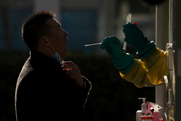 A man is tested for COVID-19 in Beijing, China, Dec. 5, 2021 (AP photo by Andy Wong).