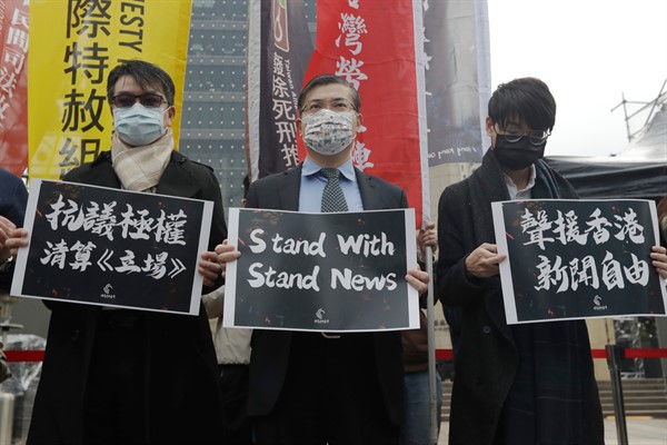 Protesters from Hong Kong and local supporters hold signs reading “Protest Against Totalitarian Liquidation of Stand News” and “Support Press Freedom in Hong Kong,” Taipei, Taiwan, Dec. 30, 2021 (AP photo by Chiang Ying-ying).