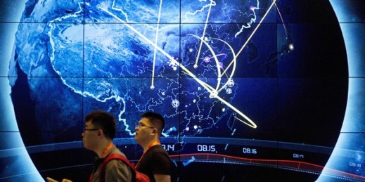 Attendees walk past an electronic display showing recent cyberattacks in China at the China Internet Security Conference in Beijing, Sept. 12, 2017 (AP photo by Mark Schiefelbein).
