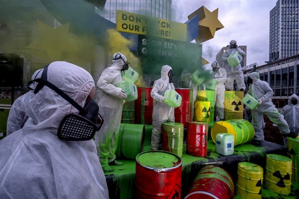 Environmental activists protest against the European Union’s “greenwashing” of nuclear energy under the Euro sculpture in Frankfurt, Germany, Jan. 11, 2022 (AP photo by Michael Probst).