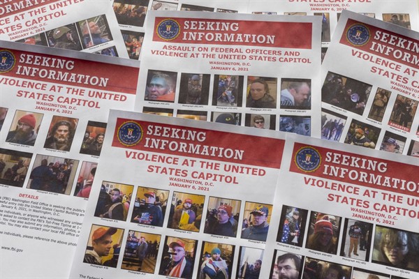 Seeking information flyers produced by the FBI to identify alleged Capitol rioters, photographed on Dec. 20, 2021 (AP photo by Jon Elswick).