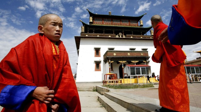 Tibetan Buddhist lamas stand outside Mongolia's largest monastery.