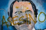 The Spanish word for “murderer” covers a mural of Nicaraguan President Daniel Ortega, as part of anti-government protests demanding his resignation in Managua, Nicaragua, May 26, 2018 (AP photo by Esteban Felix).