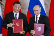 Russian President Vladimir Putin and Chinese President Xi Jinping exchange documents during a signing ceremony following their talks in the Kremlin in Moscow, Russia, June 5, 2019 (AP file photo by Alexander Zemlianichenko).