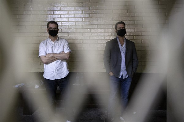 The sons of former Panamanian President Ricardo Martinelli, Ricardo and Luis Enrique Martinelli Linares, stand inside a holding cell after being detained on money-laundering charges, Guatemala City, July 7, 2020 (AP photo by Moises Castillo).