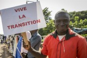 A supporter holds a placard in French reading “Long live the transition,” outside the swearing-in ceremony of the post-coup transitional president and vice president, both of whom were later deposed by a second military coup, Bamako, Mali, Sept. 25, 2020