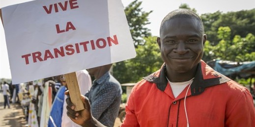 A supporter holds a placard in French reading “Long live the transition,” outside the swearing-in ceremony of the post-coup transitional president and vice president, both of whom were later deposed by a second military coup, Bamako, Mali, Sept. 25, 2020