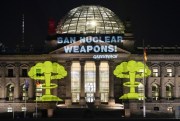 The Reichstag building is illuminated with a slogan demanding the ban of nuclear weapons by the environmental organization Greenpeace, in Berlin, Germany, Jan. 21, 2022 (AP photo by Markus Schreiber).