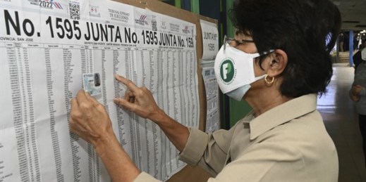 Maryory Vega checks her name on a voting roster during general elections, at a voting center at the Liceo de Moravia school in San Jose, Costa Rica, Feb. 6, 2022 (AP photo by Carlos Gonzalez).