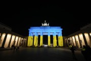 The Brandenburg Gate is illuminated in the colors of the Ukrainian flag to show solidarity with the country, Berlin, Germany, Feb. 23, 2022 (AP photo by Markus Schreiber).