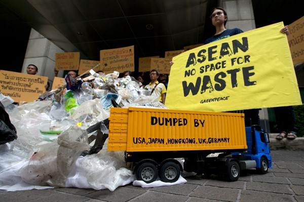Thai activists and Greenpeace activists stand in front of plastic and electronic waste at Foreign Ministry in Bangkok, Thailand, June 20, 2019 (AP photo by Sakchai Lalit).
