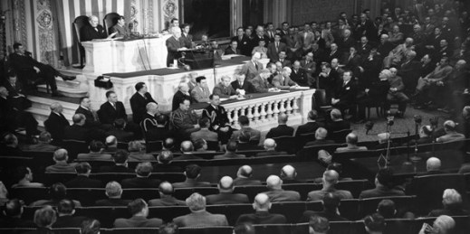 U.S. President Harry S. Truman, standing at podium, addresses a joint session of Congress in the House Chamber in Washington, D.C., March 12, 1947 (AP Photo).