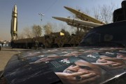 Posters of Iranian Gen. Qassem Soleimani, who was killed in Iraq in a U.S. drone attack January 2020, are seen in front of three ballistic missiles on display in Tehran, Iran, Jan. 7, 2022. Iran put (AP photo by Vahid Salemi).