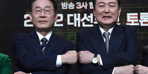 Presidential candidates Lee Jae-myung, left, of the ruling Democratic Party and Yoon Suk Yeol of the main opposition People Power Party pose for photos before a televised debate, in Seoul, South Korea, Feb. 3, 2022 (Photo by Yonhap via AP).