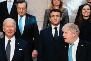 British Prime Minister Boris Johnson looks toward U.S. President Joe Biden at a group photo during an extraordinary summit at NATO headquarters, Brussels, March 24, 2022 (AP photo by Thibault Camus).