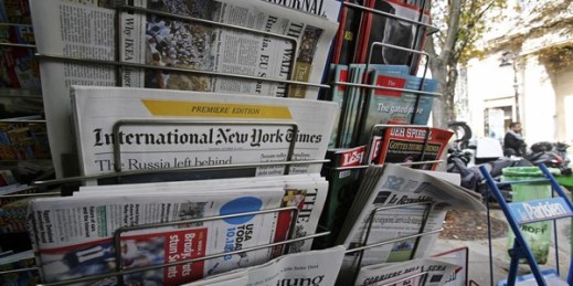 International newspapers on sale at a newsstand in Paris, Oct. 15, 2013 (AP photo by Remy de la Mauviniere).