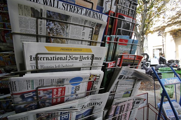 International newspapers on sale at a newsstand in Paris, Oct. 15, 2013 (AP photo by Remy de la Mauviniere).
