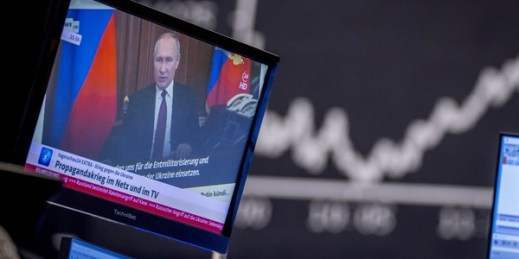Russian President Vladimir Putin appears on a television screen at the stock market in Frankfurt, Germany, Feb. 25, 2022 (AP photo by Michael Probst).