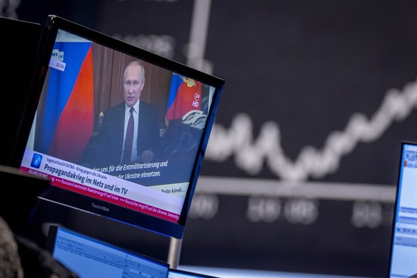 Russian President Vladimir Putin appears on a television screen at the stock market in Frankfurt, Germany, Feb. 25, 2022 (AP photo by Michael Probst).