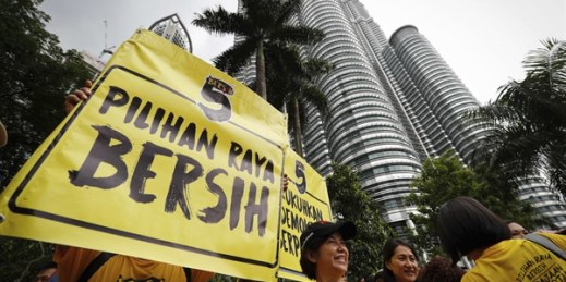 Activists from the Bersih movement show a placard reading “Clean Elections” during a rally against corruption in front of the Petronas Towers in Kuala Lumpur, Malaysia, Nov. 19, 2016 (AP photo by Vincent Thian).